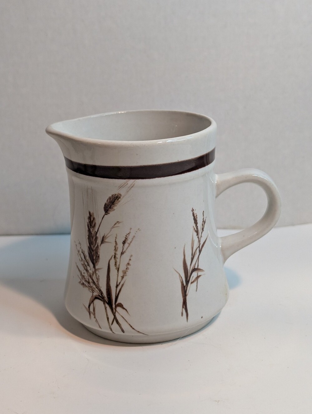 A vintage Greases Or Oats stoneware creamer or small milk jug.